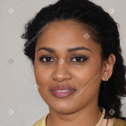 Joyful black young-adult female with long  black hair and brown eyes