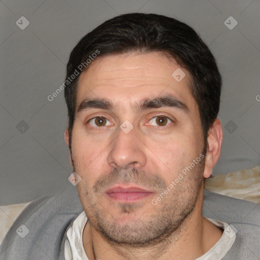 Joyful white adult male with short  black hair and brown eyes