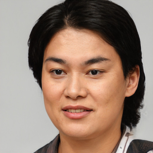 Joyful asian young-adult female with medium  brown hair and brown eyes
