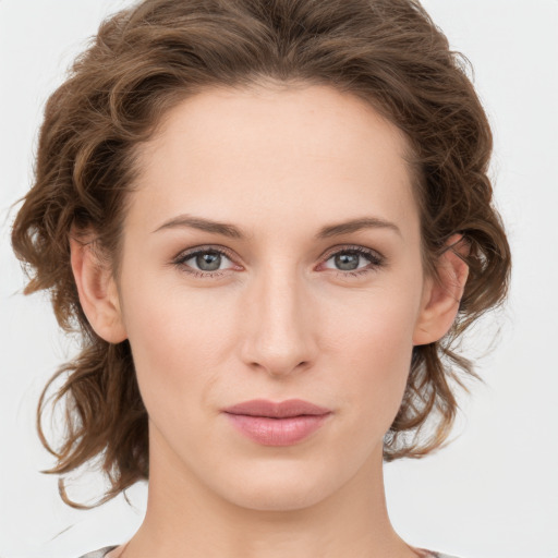 Joyful white young-adult female with medium  brown hair and green eyes