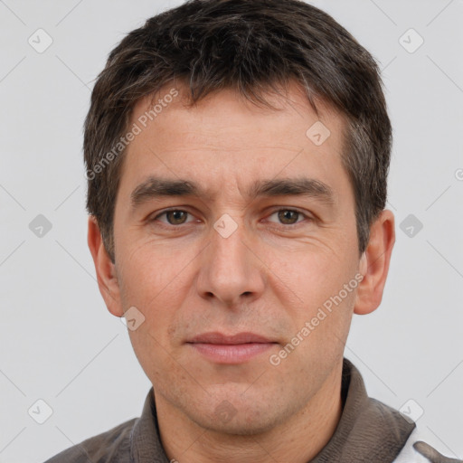 Joyful white adult male with short  brown hair and brown eyes