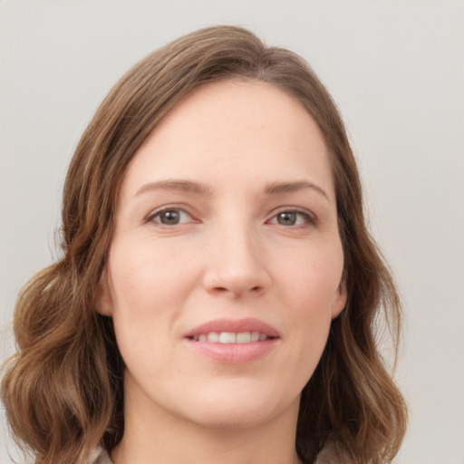 Joyful white young-adult female with medium  brown hair and green eyes