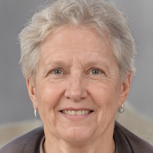 Joyful white middle-aged female with short  gray hair and brown eyes