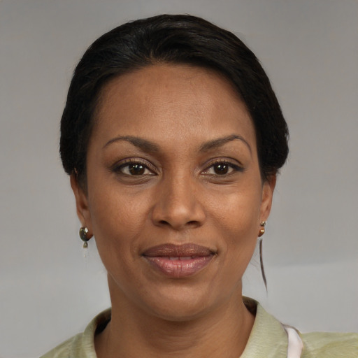 Joyful latino adult female with medium  black hair and brown eyes