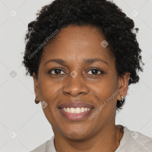 Joyful black adult female with short  brown hair and brown eyes