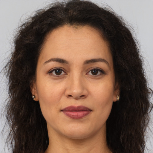 Joyful white adult female with long  brown hair and brown eyes