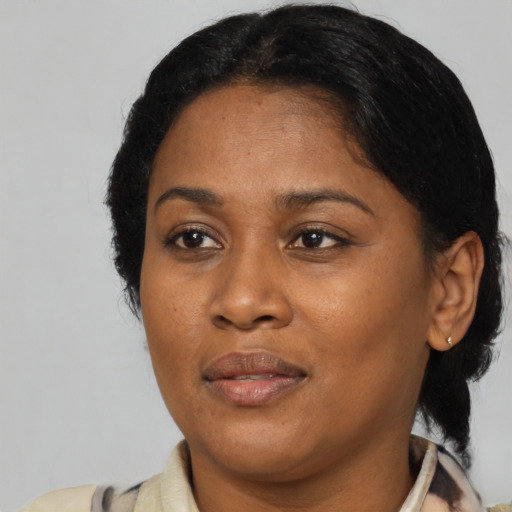 Joyful black adult female with medium  black hair and brown eyes