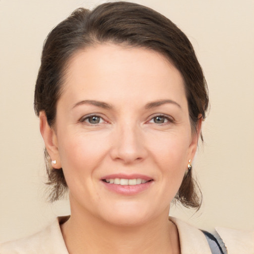 Joyful white adult female with medium  brown hair and brown eyes