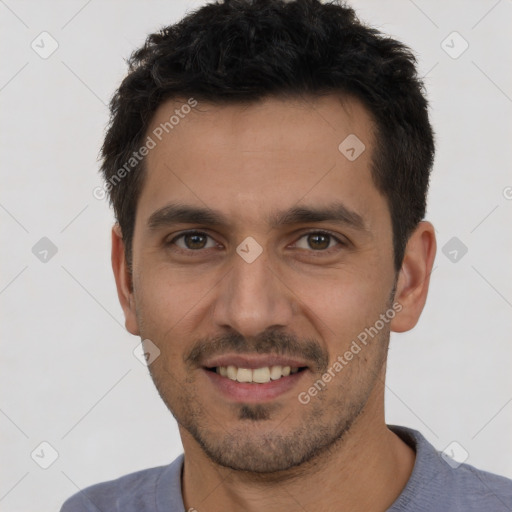 Joyful white young-adult male with short  black hair and brown eyes