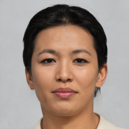 Joyful asian young-adult female with short  black hair and brown eyes