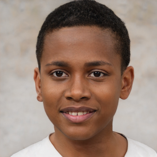 Joyful black child male with short  brown hair and brown eyes
