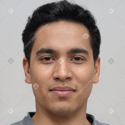 Joyful latino young-adult male with short  black hair and brown eyes