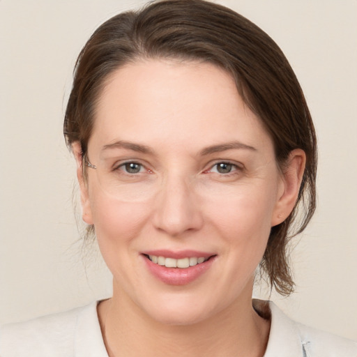 Joyful white young-adult female with medium  brown hair and grey eyes