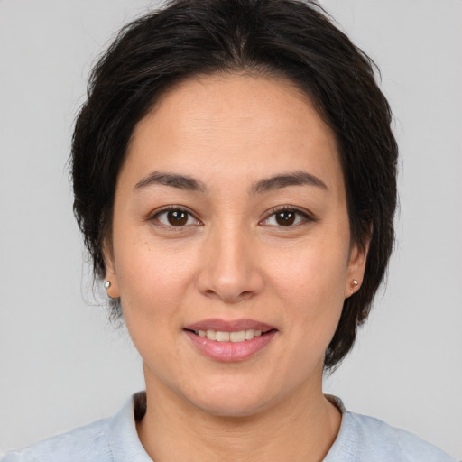 Joyful asian young-adult female with medium  brown hair and brown eyes