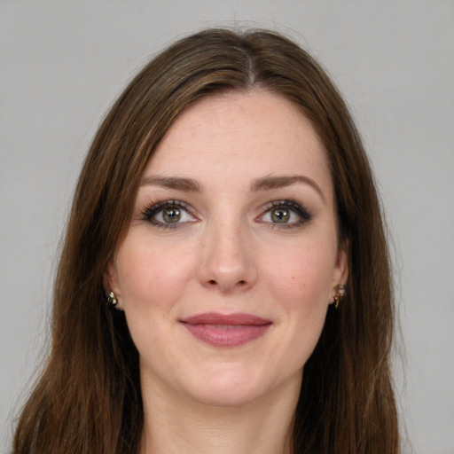 Joyful white young-adult female with long  brown hair and green eyes