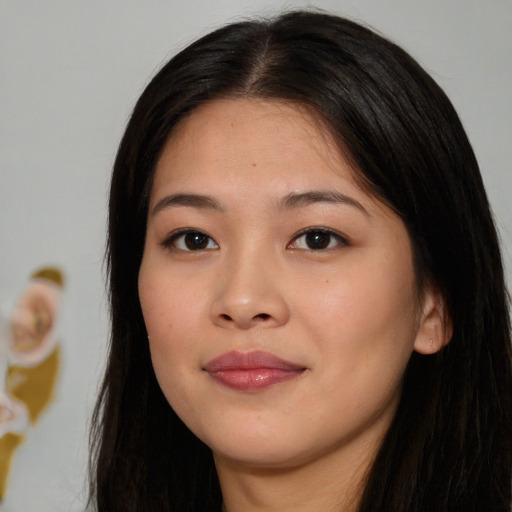 Joyful asian young-adult female with long  brown hair and brown eyes