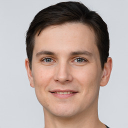 Joyful white young-adult male with short  brown hair and grey eyes