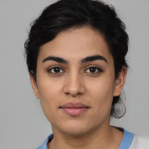 Joyful latino young-adult female with medium  black hair and brown eyes