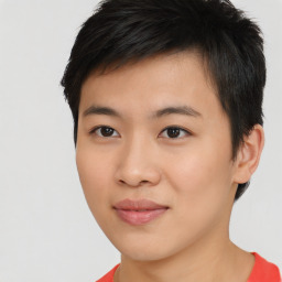 Joyful asian young-adult male with short  black hair and brown eyes