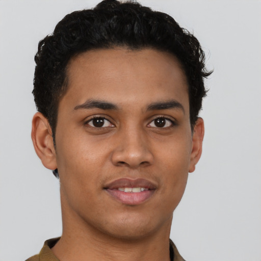 Joyful latino young-adult male with short  brown hair and brown eyes
