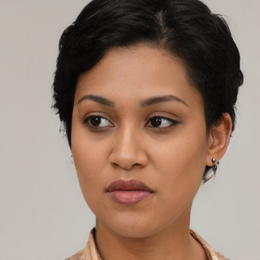 Joyful latino young-adult female with medium  black hair and brown eyes