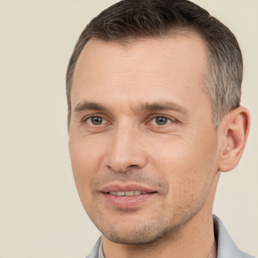 Joyful white adult male with short  brown hair and brown eyes