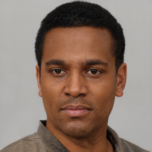 Neutral black young-adult male with short  black hair and brown eyes
