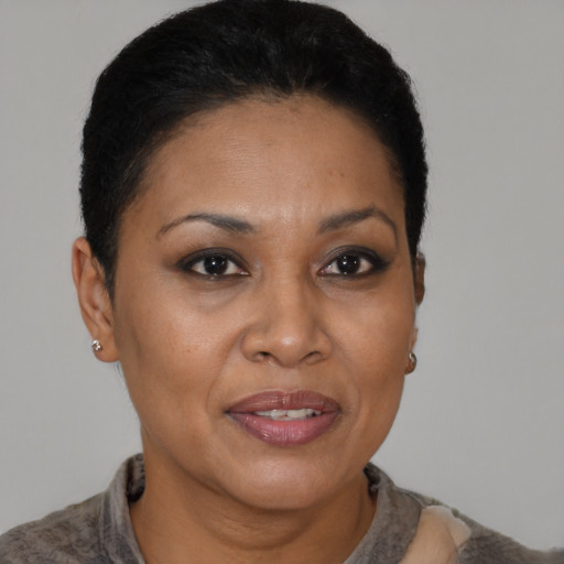 Joyful black adult female with short  brown hair and brown eyes