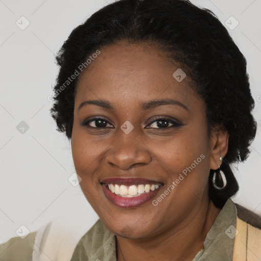 Joyful black young-adult female with short  brown hair and brown eyes