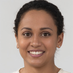 Joyful latino young-adult female with short  brown hair and brown eyes