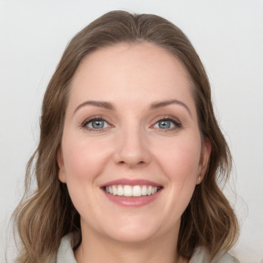 Joyful white young-adult female with medium  brown hair and blue eyes