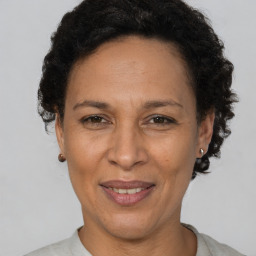 Joyful black adult female with short  brown hair and brown eyes