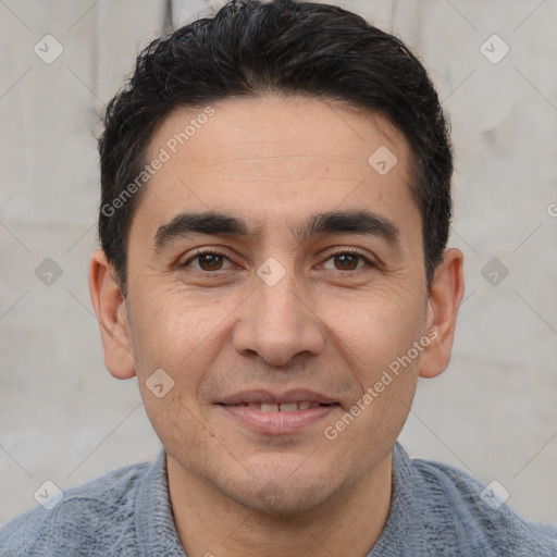 Joyful white young-adult male with short  black hair and brown eyes