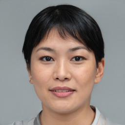 Joyful asian young-adult female with short  brown hair and brown eyes