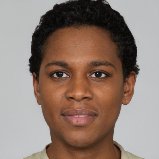 Joyful black young-adult male with short  brown hair and brown eyes