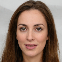 Joyful white young-adult female with long  brown hair and green eyes