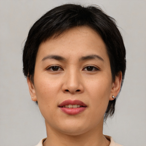 Joyful asian young-adult female with medium  brown hair and brown eyes