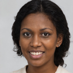 Joyful black young-adult female with medium  brown hair and brown eyes