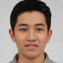 Joyful asian young-adult male with short  brown hair and brown eyes