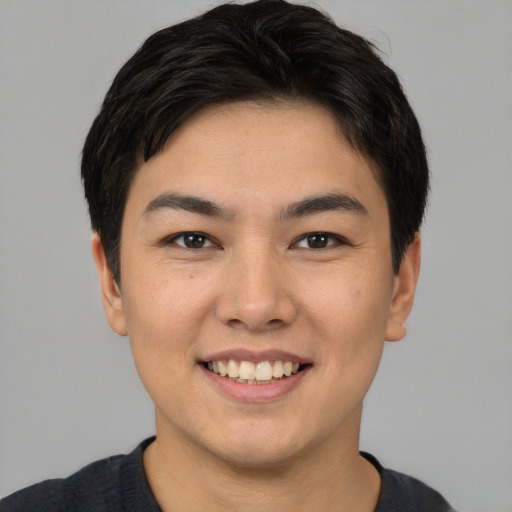 Joyful asian young-adult male with short  brown hair and brown eyes
