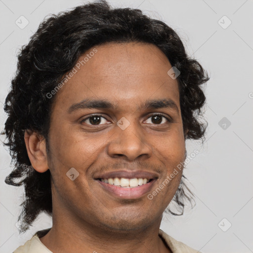 Joyful black young-adult male with short  brown hair and brown eyes