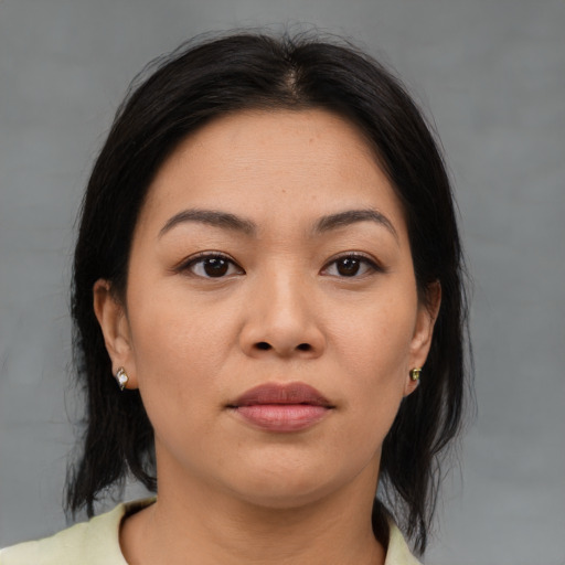 Joyful asian young-adult female with medium  brown hair and brown eyes