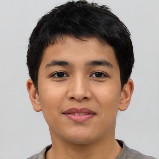Joyful asian young-adult male with short  brown hair and brown eyes