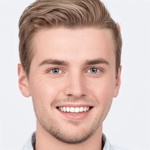 Joyful white young-adult male with short  brown hair and blue eyes