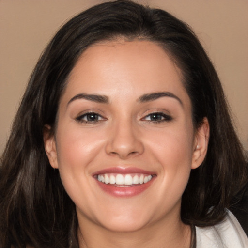 Joyful white young-adult female with long  brown hair and brown eyes