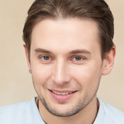 Joyful white young-adult male with short  brown hair and grey eyes