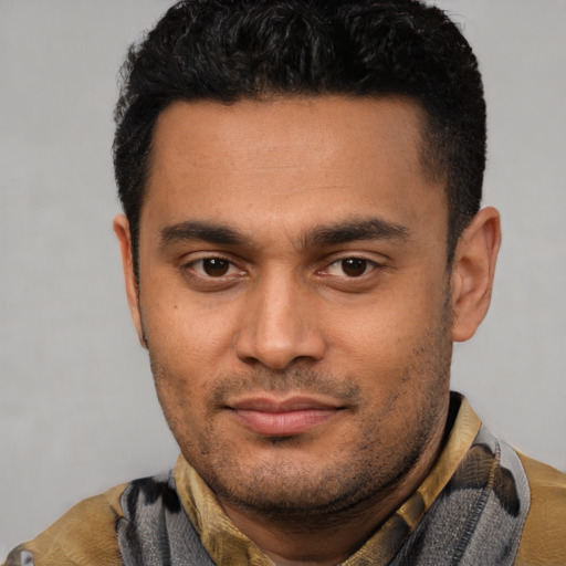Joyful latino young-adult male with short  black hair and brown eyes