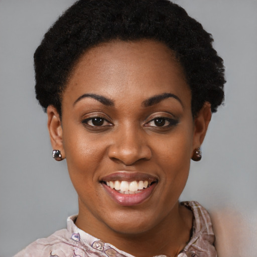 Joyful black young-adult female with short  black hair and brown eyes
