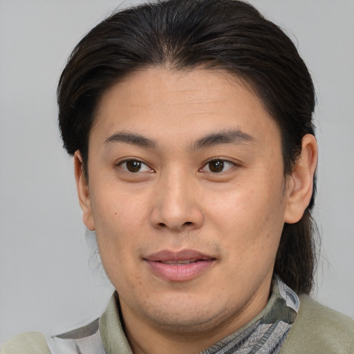 Joyful asian young-adult male with medium  brown hair and brown eyes