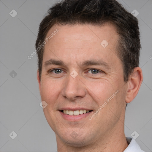 Joyful white adult male with short  brown hair and brown eyes